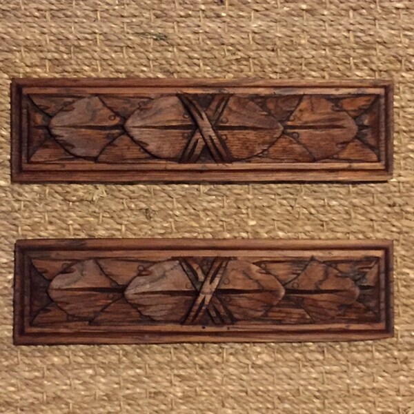A pair of classic French hand carved wooden garniture panels with naturalist leaf decorative details