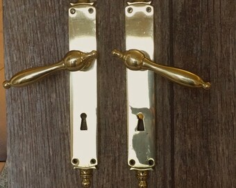 A pair of stylish mid century door handles  in the classic style