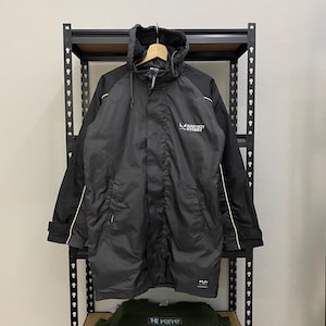May include: A black hooded long-sleeved jacket with white piping on the sleeves and shoulders. The jacket has a zipper closure and a logo that reads "Bad Boy Street".