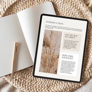 May include: A digital tablet displaying a journal introduction page with the text "Get Ready to Shift" and "Why This Journal?" The text is in a white box with a black outline. The background is a blurry image of dried flowers.