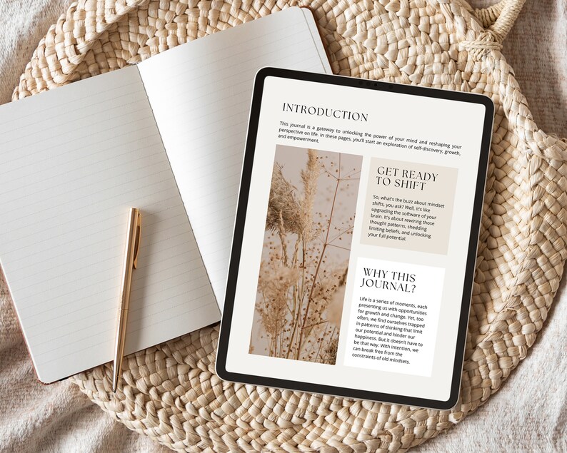 May include: A digital tablet displaying a journal introduction page with the text "Get Ready to Shift" and "Why This Journal?" The text is in a white box with a black outline. The background is a blurry image of dried flowers.