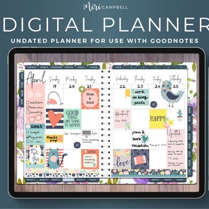 May include: A digital planner app on a tablet screen with a floral design. The planner is undated and designed for use with Goodnotes. The screen shows the month of April with daily boxes for scheduling. The planner includes stickers with various designs, including a cat, a bird, and a heart.