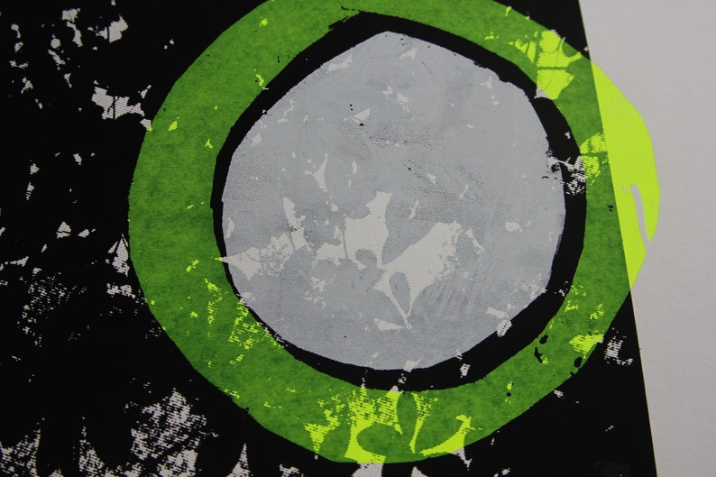 May include: Abstract art print featuring a green circle surrounding a grey circle against a black backdrop.