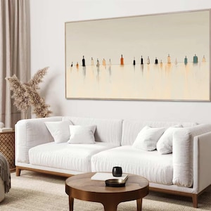 May include: A large rectangular wall art piece featuring a series of small, stylized bottle silhouettes in various shades of black, brown, and blue, set against a pale cream background with soft, vertical reflections extending downward.