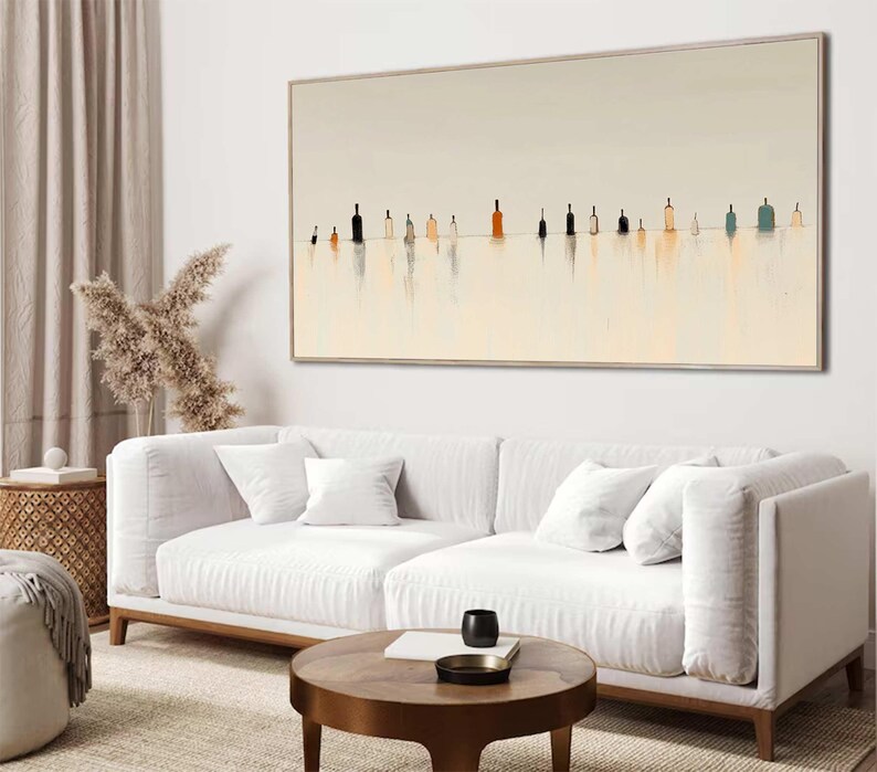 May include: A large rectangular wall art piece featuring a series of small, stylized bottle silhouettes in various shades of black, brown, and blue, set against a pale cream background with soft, vertical reflections extending downward.