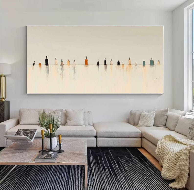 May include: A large horizontal rectangular wall art piece featuring a series of abstract bottle silhouettes in shades of black, orange, and blue, arranged in a single line against a pale cream background with soft vertical reflections below.