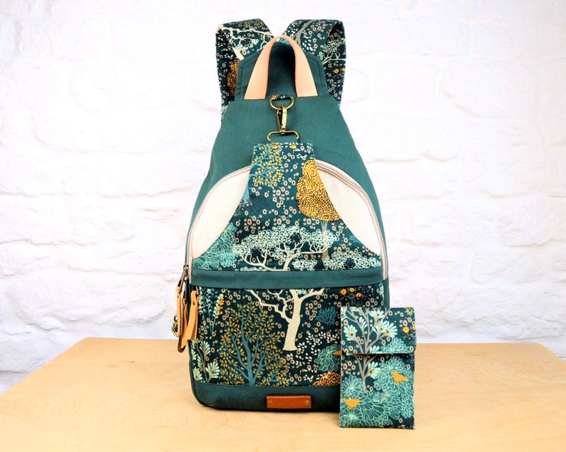 Sewing Pattern for a large backpack with lots of pockets, unisex style can be worn by men or women, converts to a sling bag, with matching phone case pattern, fully lined backpack for laptop, DIY sewing project, contemporary design rucksack to make yourself.