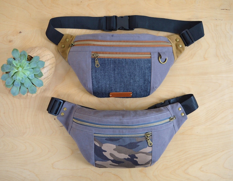 May include: Two fanny packs, one with a denim and brown fabric design and the other with a camouflage and gray fabric design.