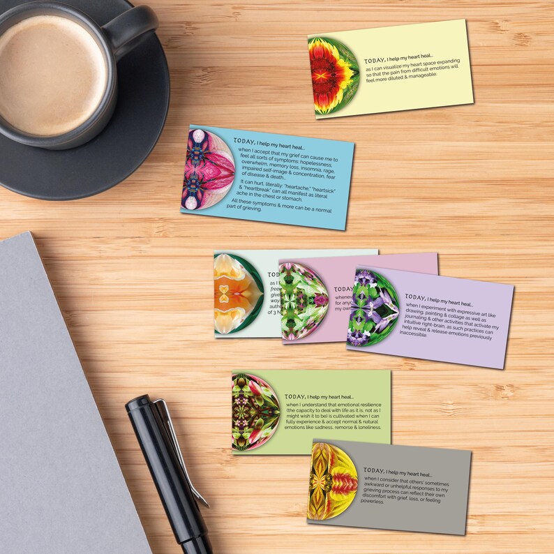 A printed version of the Heart Healing Grief Deck, placed beside a journal and cup of coffee, creating a peaceful self-care ritual space for grief support.