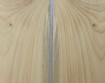 May include: Two pieces of light brown wood veneer with a thin silver line separating them. The wood grain is visible and has a natural, light brown color.