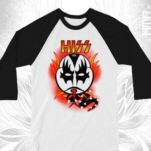 May include: A white and black baseball tee shirt with a cartoon image of a KISS character with a snake and the word "HISS" in red.