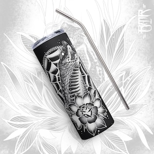 May include: Black and white stainless steel tumbler with a graphic of a snake and a flower. The tumbler has a straw.