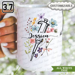 May include: White 15oz stemless wine glass with a floral design, butterflies, and the name "Jessica". The glass features a customizable design with a hammer and a pipette. The glass is all white.