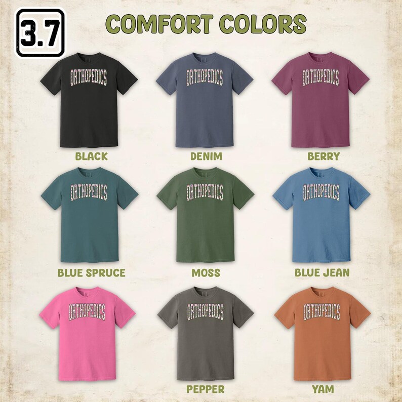 May include: Nine t-shirts in different colors, each with the word "ORTHOPEDICS" printed on the front. The colors are black, denim, berry, blue spruce, moss, blue jean, pepper, and yam.