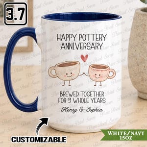 May include: A white ceramic mug with a dark blue interior and handle. The front features a graphic of two smiling coffee cups holding hands with a red heart above them. Text reads: HAPPY POTTERY ANNIVERSARY, BREWED TOGETHER FOR 9 WHOLE YEARS, Henry & Sophia.