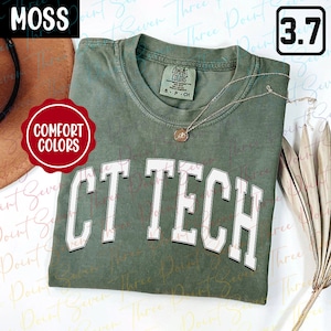 May include: A green t-shirt with the words "CT TECH" in white lettering. The shirt is folded and has a tag that says "Comfort Colors".