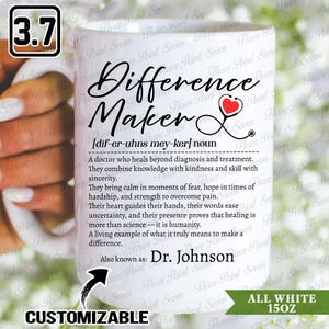 May include: White ceramic mug with the words "Difference Maker" in black script, a red heart stethoscope graphic, and a definition. The mug is customizable and holds 15 ounces.