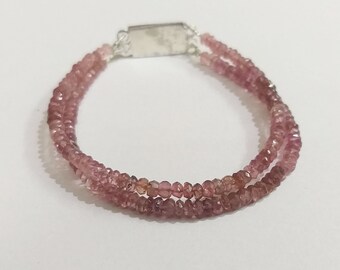 May include: A double-strand bracelet made with pink tourmaline beads. The bracelet has a silver clasp.