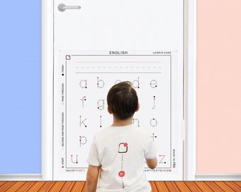 May include: A child traces the lowercase letters of the English alphabet on a white poster with red and black dots. The poster has the words "ENGLISH" and "LOWER CASE" at the top. The child is wearing a white t-shirt with the words "SMARTYDOTS" and "JARTYDOTS.COM" printed on it.