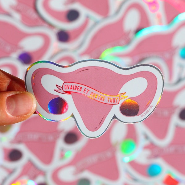 Feminist sticker in an holographic vinyl ovaries with a wordplay on "Against all odds" in french for exterior or customizing objects