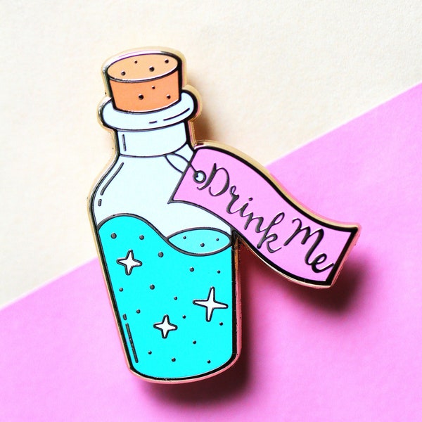 Drink me bottle enamel pin from the novel Alice in Wonderland by Lewis Carroll shrinking potion