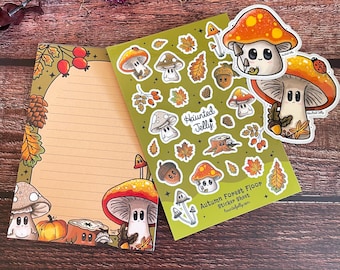 May include: A sticker sheet featuring a variety of cute mushroom illustrations with autumnal colors and details. The sheet includes a variety of mushrooms, leaves, acorns, and other forest elements. The sheet is titled "Autumn Forest Floor Sticker Sheet" and includes the website "hauntedjelly.com".