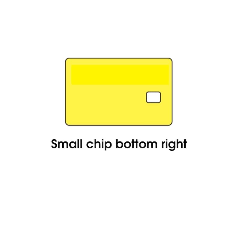 May include: A yellow credit card with a small chip in the bottom right corner. The card has a rectangular shape with rounded corners and a lighter yellow stripe across the top. The text "Small chip bottom right" is below the card.