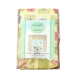 May include: A yellow and green floral valance with a scalloped edge. The valance is labeled "Waverly Home Classics" and "double scallop valance". The valance is 42 inches wide and 15 inches long.