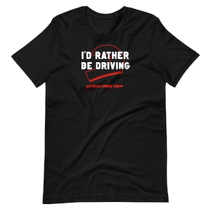 May include: Black t-shirt with white text that reads "I'd rather be driving" with a red outline of a racing helmet. The text "Automo Speed Crew" is printed in red below the helmet.
