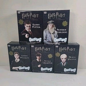 May include: A collection of six Harry Potter Bust-Ups model kits featuring characters like Harry Potter, Professor Dumbledore, Ginny Weasley, Neville Longbottom, and Draco Malfoy. Each box is black with character images and the Bust-Ups logo.