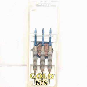 May include: Three darts with blue tips and gold and silver patterned barrels are displayed in a clear plastic case. The darts are labeled "GOLD N/S". The case is on a white background.