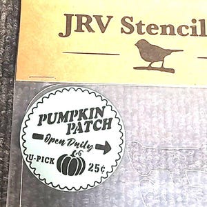 May include: A stencil with the text "JRV Stencil" and a silhouette of a bird. A circular sticker reads "Pumpkin Patch" with "Open Daily", an arrow, a pumpkin graphic, and "U-Pick 25¢".