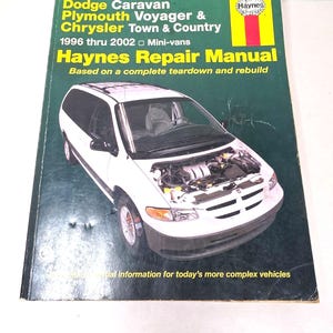 May include: A Haynes Repair Manual for 1996 thru 2002 Dodge Caravan, Plymouth Voyager, and Chrysler Town & Country mini-vans. The dark green cover features a white mini-van with its hood open, yellow text, and the Haynes logo in the top right corner.