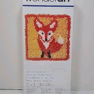 May include: A Wonderart latch hook kit featuring a colorful fox design. The kit includes the materials to create a 12-inch by 12-inch (30 cm x 30 cm) rug. The packaging includes the text "LATCH HOOK KIT" and "Little Fox".