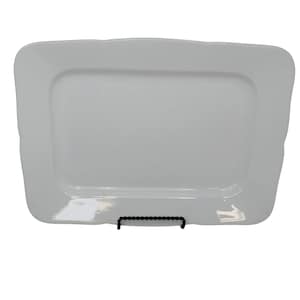 May include: A rectangular white serving platter with gently scalloped edges. The plate is supported by a black metal stand, showcasing its clean lines and simple elegance. Ideal for serving appetizers or desserts.