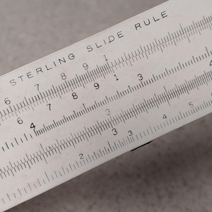 May include: A set of three ceramic mugs with a speckled, matte finish. The mugs are in shades of cream, light gray, and dark gray. Each mug has a simple, minimalist design and a rounded handle. The mugs are suitable for coffee, tea, or other beverages.