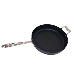 May include: A black, round frying pan with a long, silver handle and a smaller, silver handle on the opposite side. The pan is made of a dark material and is designed for cooking. The handle is approximately 15 inches long.