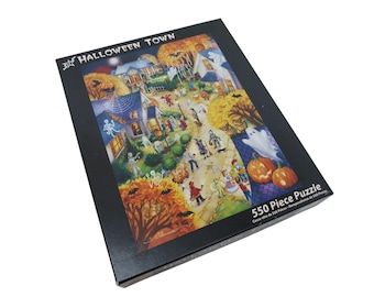 May include: A black box featuring a 550-piece Halloween Town puzzle. The puzzle art depicts a festive Halloween scene with costumed figures, pumpkins, and a haunted house. The box has the words "Halloween Town" and "550 Piece Puzzle".
