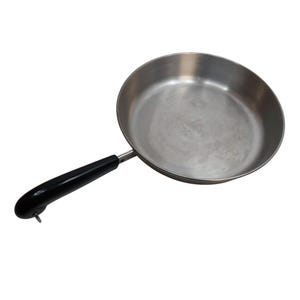 May include: A stainless steel frying pan with a black handle. The pan is round with a slightly sloped edge and a long, curved handle. The handle is black and has a small hole at the end. The pan is designed for cooking.