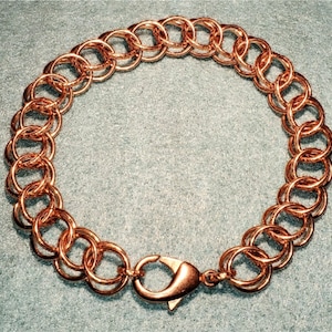 May include: A rose gold chain bracelet with a lobster clasp closure.