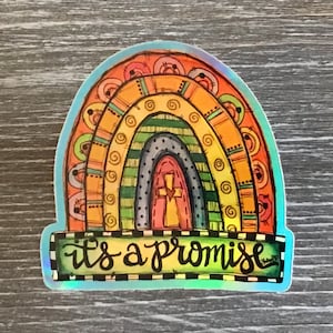 May include: A colorful rainbow sticker with a cross in the center and the text "it's a promise" at the bottom. The sticker has a holographic finish.