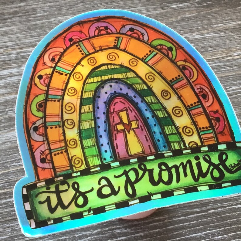 May include: A colorful rainbow sticker with a cross in the center and the text "it's a promise" at the bottom.