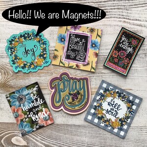 May include: Set of ten colorful magnets with inspirational quotes and floral designs. The magnets feature phrases like "Choose Joy", "Have a Beautiful Day", "Pray Without Ceasing", "Always Be Humble and Kind", "You Are Enough", and "It Is Well With My Soul".