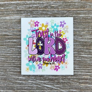 May include: A white card with a colorful floral design and the text "Trust in the LORD with all your heart Proverbs 3:5".