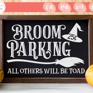 May include: A framed black chalkboard sign with white text that reads "BROOM PARKING" and "ALL OTHERS WILL BE TOAD." A witch's hat with "25¢" is on the right. The sign is decorated with pumpkins, perfect for Halloween.