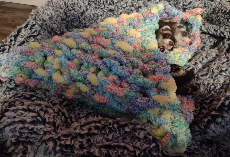 a cute hand knitted snuggle cone for small animals / ferrets hand knitted in soft thick chunky yarn in "cereal" (fruit loop colored) - great for burrowing and snuggling