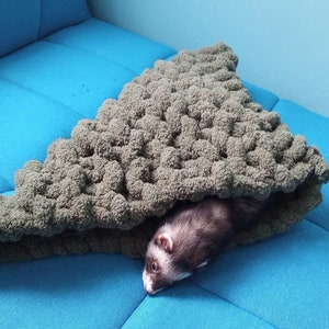 a cute hand knitted snuggle cone for small animals / ferrets hand knitted in soft thick chunky yarn in olive - great for burrowing and snuggling