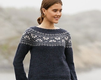 May include: A navy blue sweater with a white and gray geometric pattern across the chest. The long-sleeved sweater is made of a soft material and is paired with blue jeans. The sweater has a round neckline and a ribbed hem.