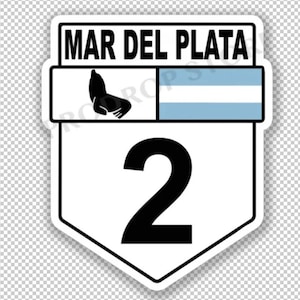 May include: A white and black road sign with the text "MAR DEL PLATA" and the number "2" in black. The sign features a black silhouette of a sea lion and a blue and white stripe pattern.