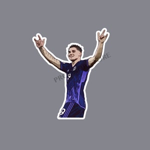 May include: A digital illustration of a football player celebrating a goal. The player is wearing a purple and black jersey with white trim. The player has their arms raised in the air and is smiling.